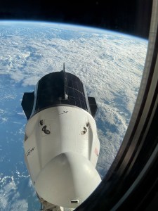 The SpaceX Dragon Freedom spacecraft is pictured from a window aboard the SpaceX Dragon Endurance spacecraft. Both spacecraft are docked to ports on the International Space Station's Harmony module. Freedom is seen moments before undocking from Harmony's forward port with the Axiom Mission 3 crew aboard.