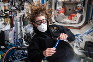 NASA astronaut and Expedition 70 Flight Engineer Loral O'Hara wears personal protective equipment during scieintific maintenance duties aboard the International Space Station's Destiny laboratory module.