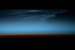 Noctilucent clouds, wispy clouds in Earth's upper atmosphere illuminated by the sunlight just after sunset, are pictured from the International Space Station as it orbited 269 miles above the south Pacific Ocean.