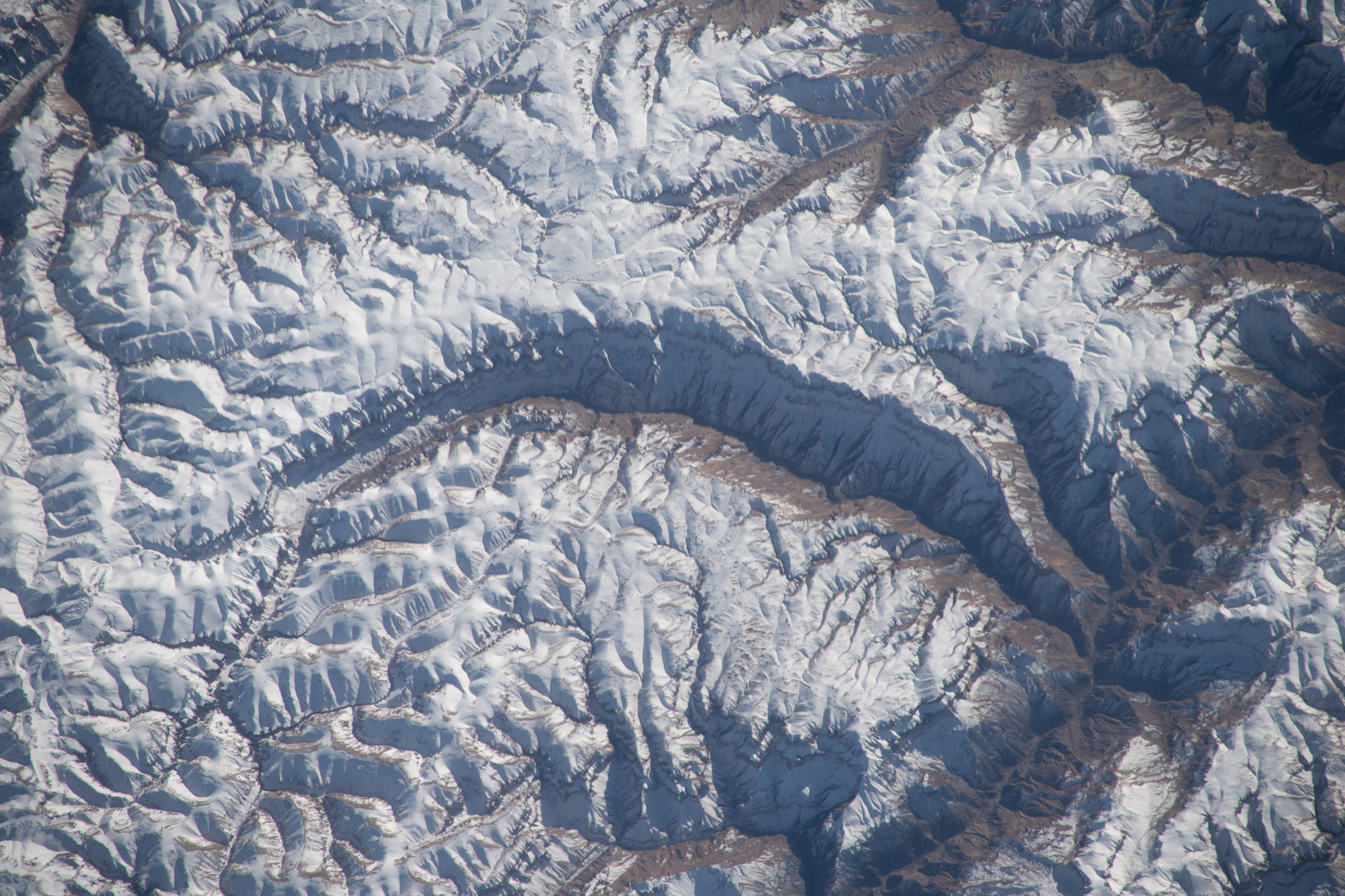 A portion of the Pamir Mountains, a mountain range at the northwest junction of the Himalayas and crossing several Central Asia countries, is pictured from the Interntional Space Station as it orbited 261 miles above Uzbekistan.
