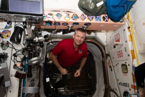 ESA (European Space Agency) astronaut and Expedition 70 Commander Andreas Mogensen smiles for a portrait as he maneuvers in the vestibule in between the Unity and Tranquility modules aboard the International Space Station.