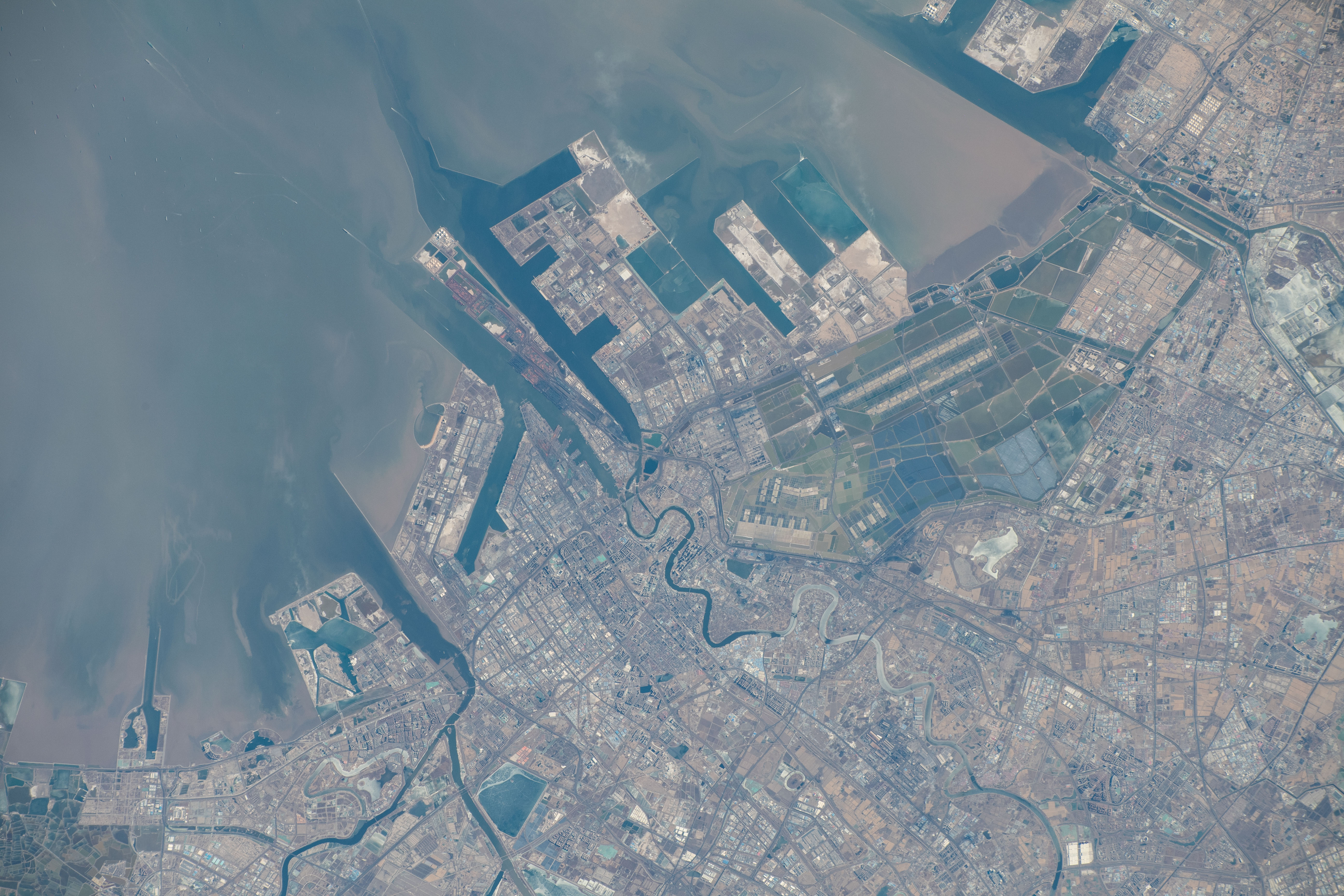 The port of Tianjin, China, on the Bohai Sea, a city with a population of over 13.8 million and known for its high scientififc output, is pictured from the International Space Station as it orbited 262 miles above.