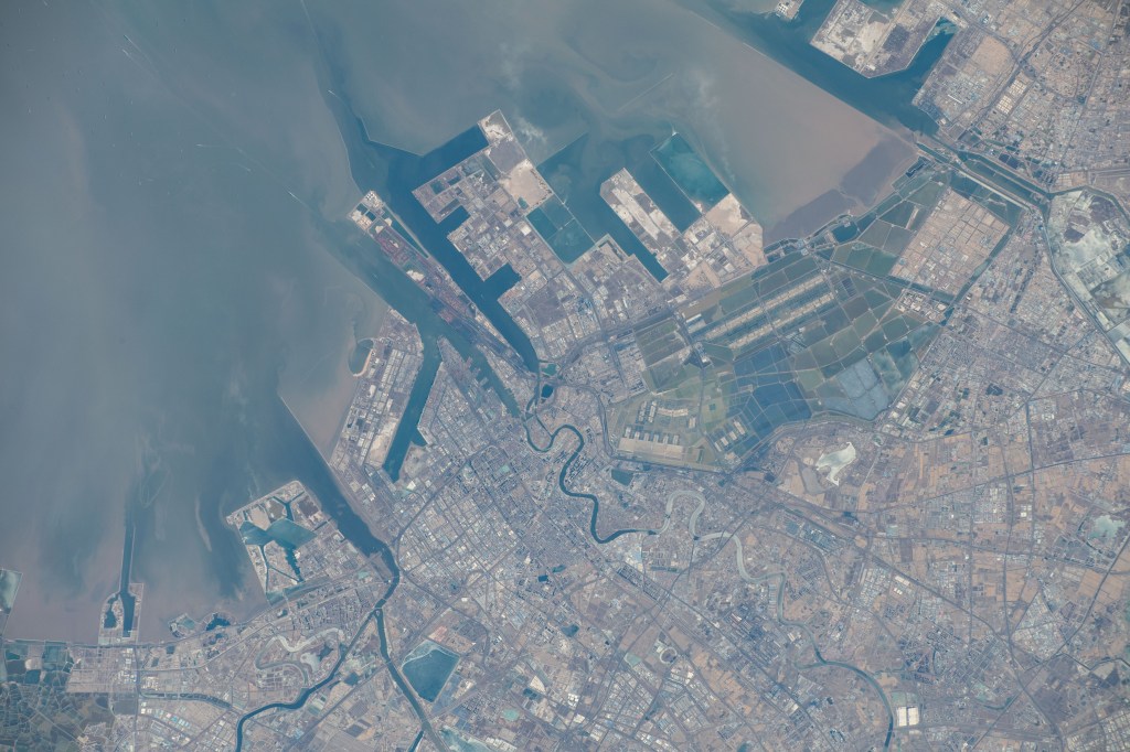 The port of Tianjin, China, on the Bohai Sea, a city with a population of over 13.8 million and known for its high scientififc output, is pictured from the International Space Station as it orbited 262 miles above.