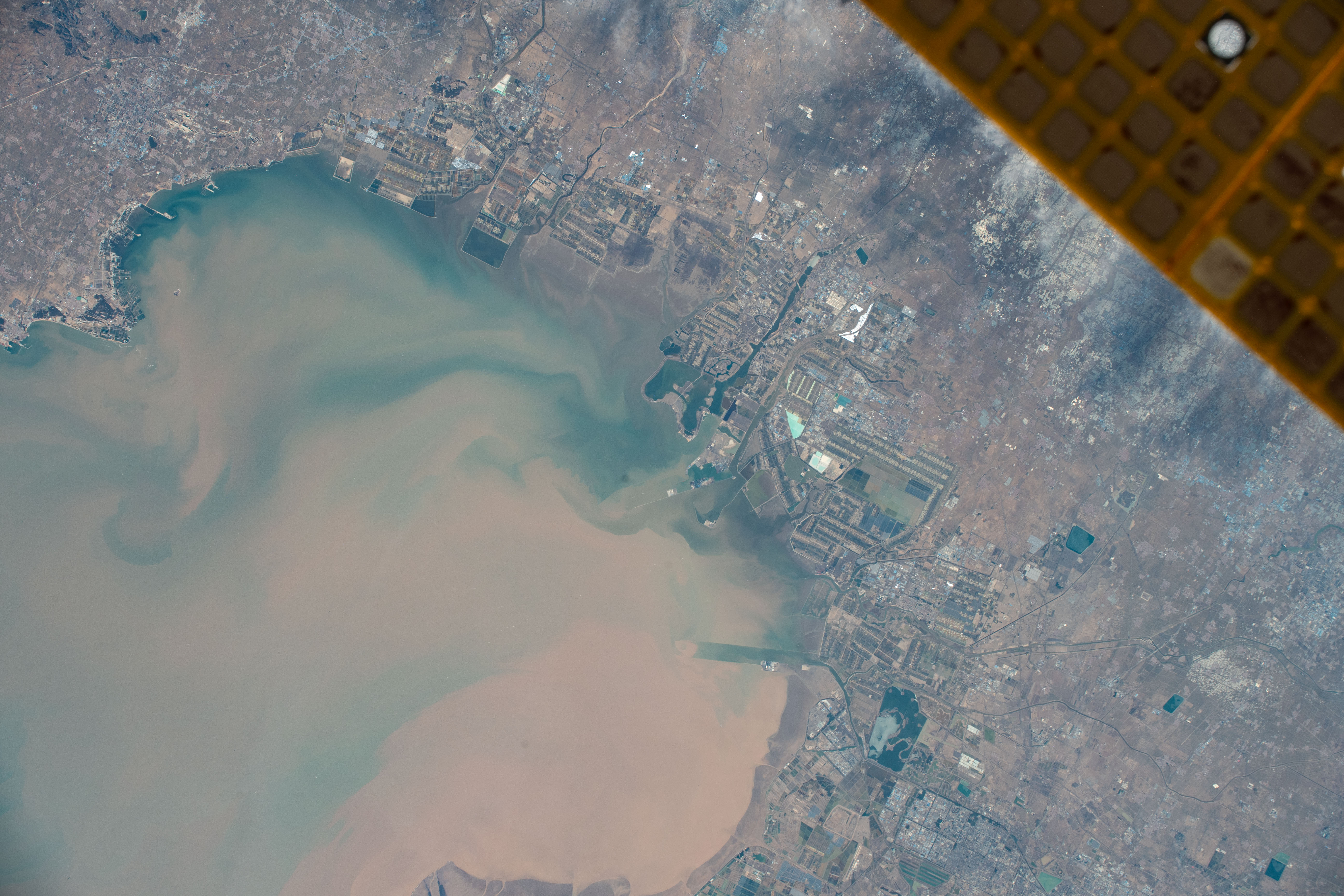 Weifang, China, a city with a population of nearly 9.4 million on Laizhou Bay, is pictured from the International Space Station as it orbited 261 miles above.