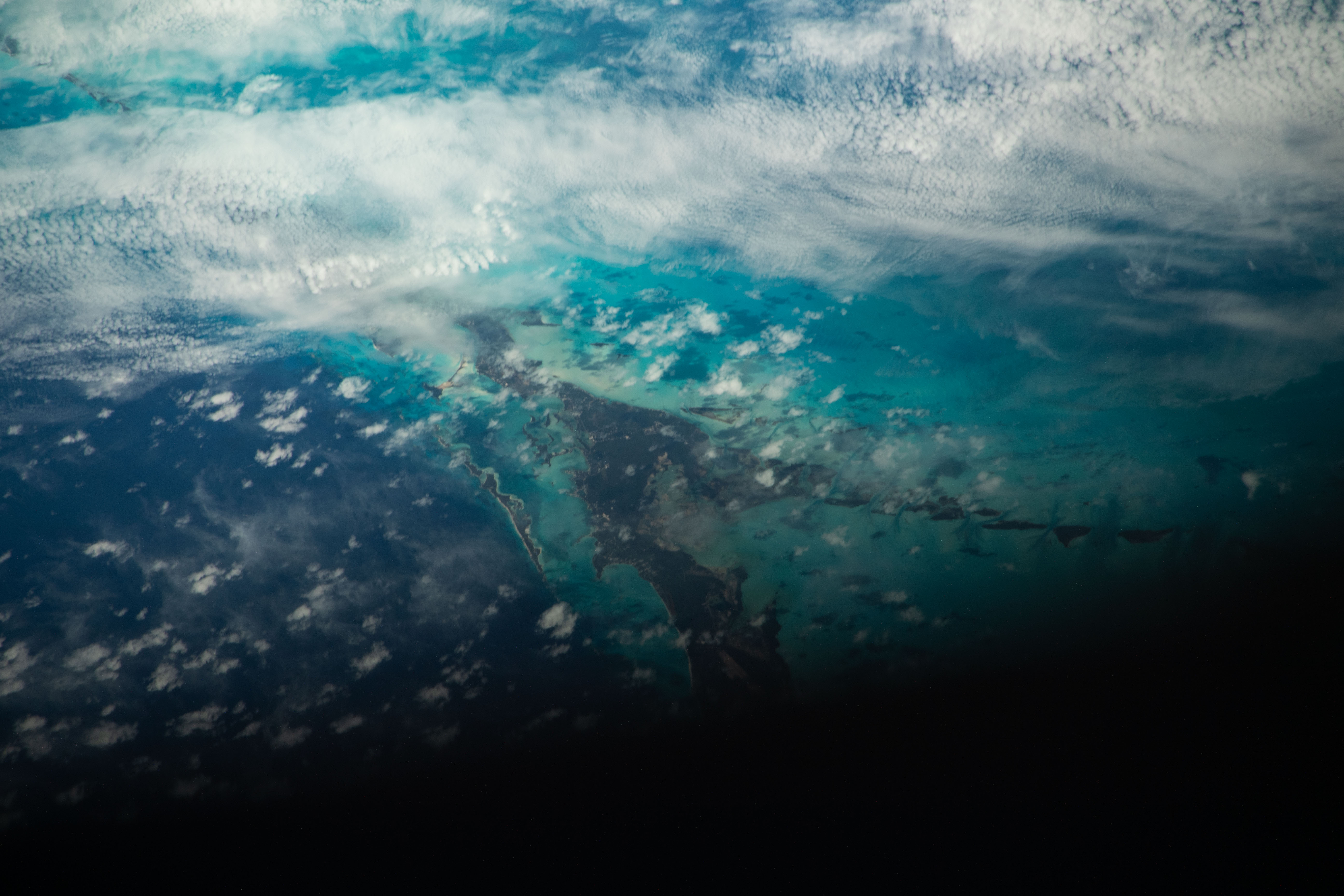 iss070e093880 (Feb. 15, 2024) -- Orbital nighttime sweeps over the teal waters of The Bahamas as the International Space Station soared 260 miles above.
