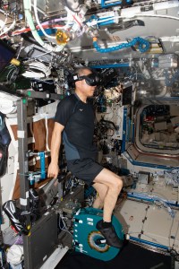 JAXA (Japan Aerospace Exploration Agency) astronaut and Expedition 70 Flight Engineer Satoshi Furukawa pedals on an exercise cycle, also known as the Cycle Ergometer Vibration Isolation System (CEVIS), while watching a movie wearing virtual reality goggles.