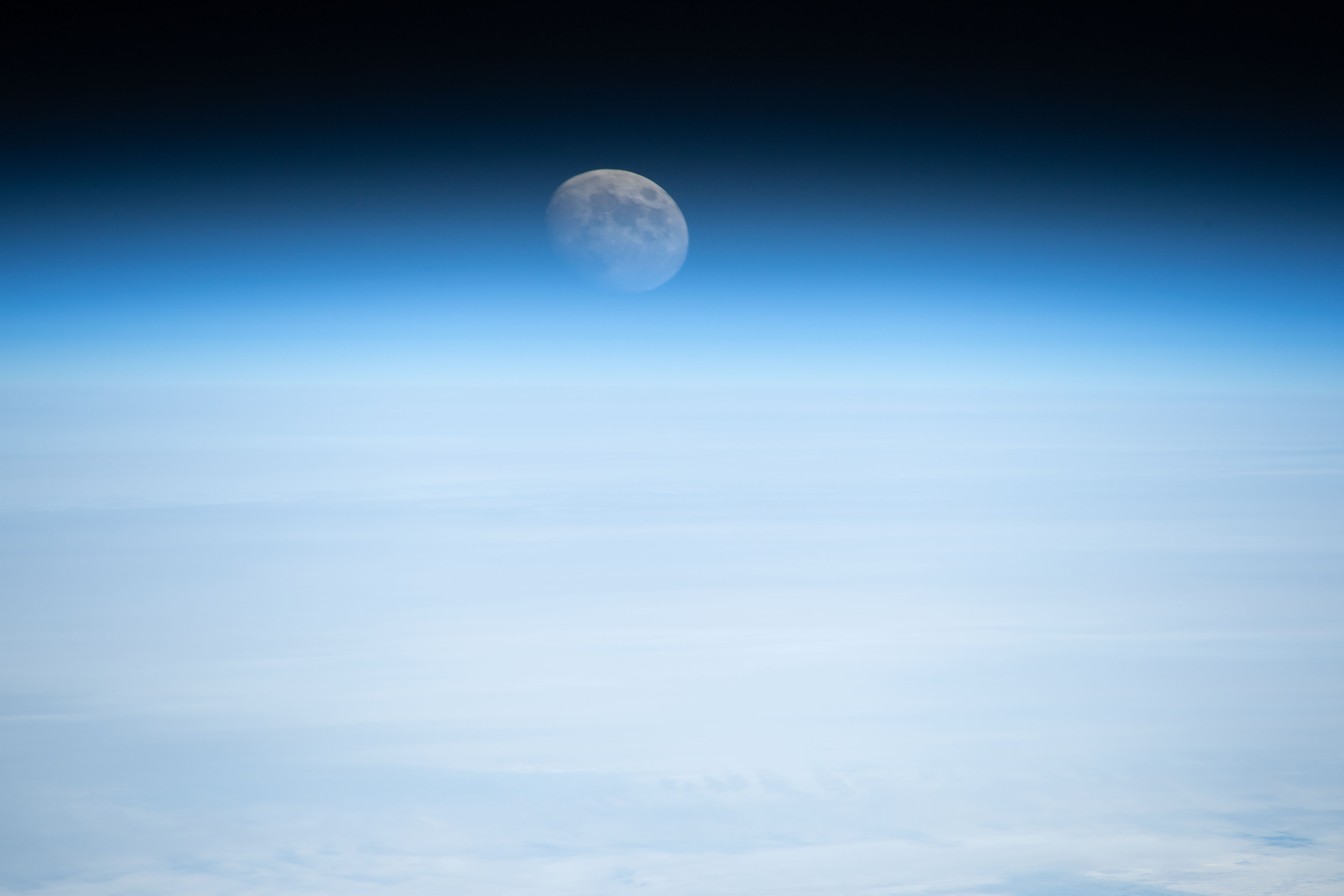 Earth's atmosphere refracts the light of the waxing gibbous Moon in this photograph from the International Space Station as it orbited 261 miles above the Atlantic Ocean off the coast of the northeastern United States.