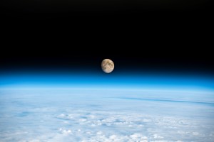 The waxing gibbous Moon is pictured above the Earth's horizon in this photograph from the International Space Station as it orbited 262 miles above a cloudy Western Europe.