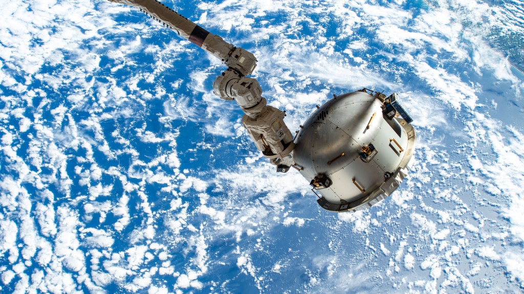 The NanoRacks Bishop airlock is attached to the Canadarm2 robotic arm's latching end effector. Bishop can be uninstalled from its home on the Tranquility module for portable operations. It can also be used to stow cargo and extract or install payloads. The International Space Station was orbiting 264 miles above the Atlantic Ocean off the coast of southern Brazil at the time of this photograph.
