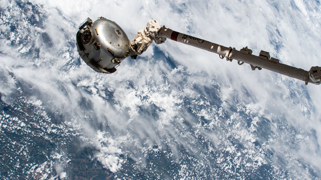 The NanoRacks Bishop airlock is attached to the Canadarm2 robotic arm's latching end effector. Bishop can be uninstalled from its home on the Tranquility module for portable operations. It can also be used to stow cargo and extract or install payloads. The International Space Station was orbiting 261 miles above Brazil near the Bolivian border at the time of this photograph.