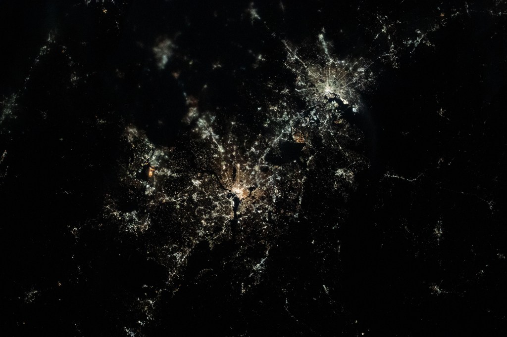 This nighttime, near overhead view shows Washington, D.C. (center) and Baltimore, Maryland (upper right) on Chesapeake Bay. Expedition 70 Flight Engineer Loral O'Hara of NASA photographed the area as the International Space Station orbited 261 miles above.