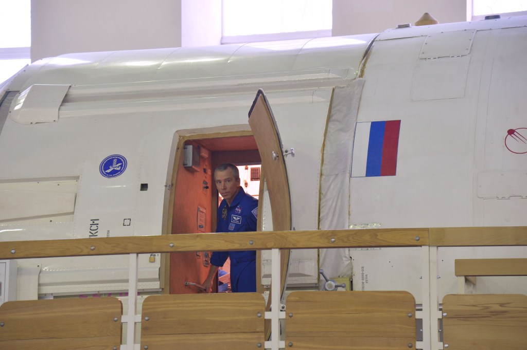 At the Gagarin Cosmonaut Training Center in Star City, Russia, Expedition 55 prime crew member Drew Feustel of NASA peers out of a Russian module training mockup during a day of qualification exams Feb. 20. Feustel, Ricky Arnold of NASA and Oleg Artemyev of Roscosmos will launch March 21 on the Soyuz MS-08 spacecraft from the Baikonur Cosmodrome in Kazakhstan for a five month mission on the International Space Station.