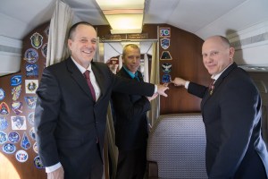 jsc2018e010814 - Aboard a Gagarin Cosmonaut Training Center aircraft en route to their launch site at the Baikonur Cosmodrome in Kazakhstan, Expedition 55 crewmembers Ricky Arnold of NASA (left), Drew Feustel of NASA (center) and Oleg Artemyev of Roscosmos (right) point to their Soyuz crew patch March 4 during their flight from their training base outside of Moscow. The trio will launch March 21 on the Soyuz MS-08 spacecraft for a five month mission on the International Space Station.