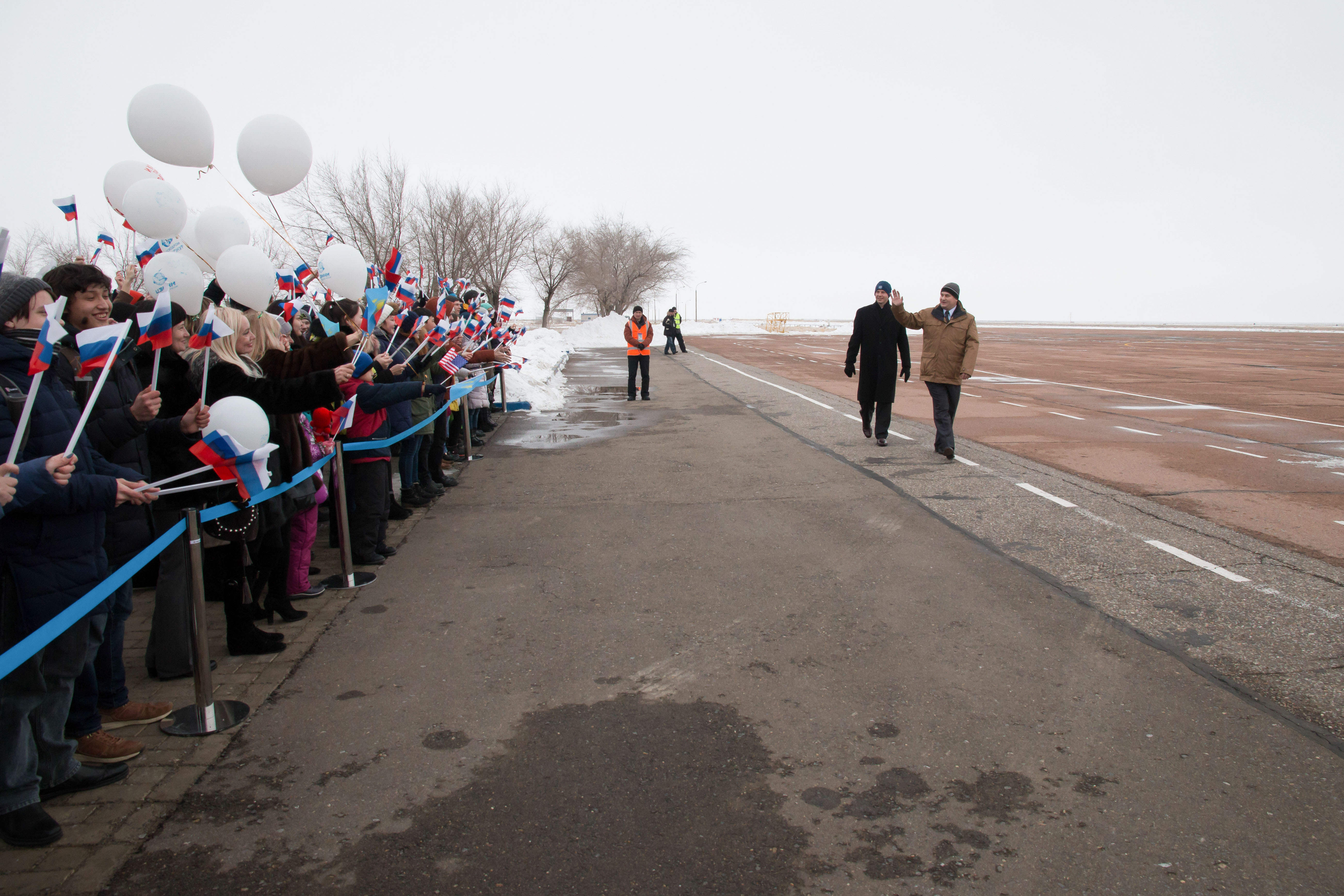 Expedition 55 backup crewmembers Nick Hague of NASA and Alexey Ovchinin of Roscosmos wave to local school children after arriving at the airstrip in Baikonur, Kazakhstan March 4 following a flight from their training base outside of Moscow. They are serving as backups to Ricky Arnold and Drew Feustel of NASA and Oleg Artemyev of Roscosmos, who will launch March 21 on the Soyuz MS-08 spacecraft for a five month mission on the International Space Station.