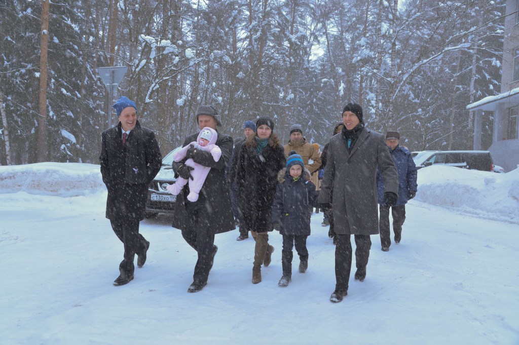Bundled up against a blizzard, Expedition 55 crewmember Oleg Artemyev of Roscosmos (center) holds his infant child March 4 at the Gagarin Cosmonaut Training Center in Star City, Russia as he and his crewmates walk to a waiting bus to take them to a nearby airport for a flight to the launch site at the Baikonur Cosmodrome in Kazakhstan. Looking on are crewmates Ricky Arnold of NASA (left) and Drew Feustel of NASA (right). The trio will launch March 21 on the Soyuz MS-08 spacecraft for a five month mission on the International Space Station.