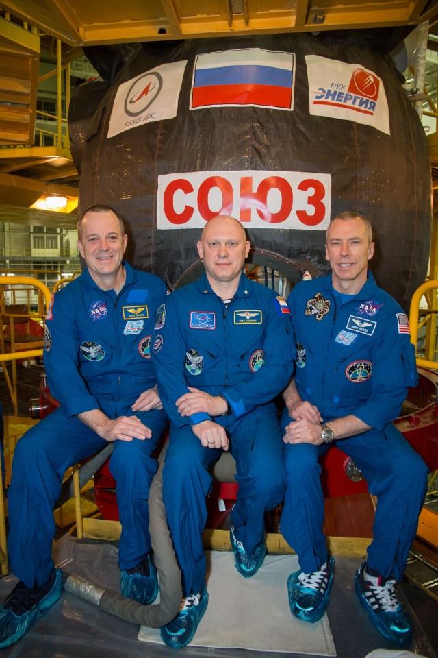 At the Baikonur Cosmodrome in Kazakhstan, Expedition 55 crewmembers Ricky Arnold of NASA (left), Oleg Artemyev of Roscosmos (center) and Drew Feustel of NASA (right) pose for pictures in front of their Soyuz spacecraft March 5 as part of their vehicle fit check activities. They will launch March 21 in the Soyuz MS-08 spacecraft from Baikonur for a five-month mission on the International Space Station.