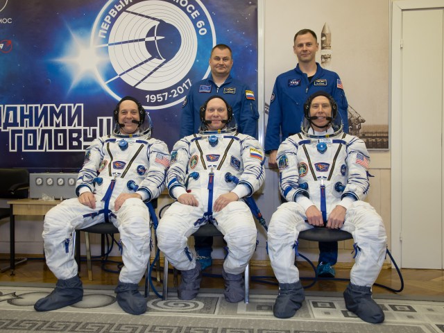 At the Baikonur Cosmodrome in Kazakhstan. Expedition 55 crewmembers Ricky Arnold of NASA (front row, left), Oleg Artemyev of Roscosmos (front row, center) and Drew Feustel of NASA (front row, right) pose for pictures March 5 during the crew’s first vehicle fit check activities. Behind them are the backup crewmembers, Alexey Ovchinin of Roscosmos (back row, left) and Nick Hague of NASA (back row, right). Arnold, Artemyev and Feustel will launch March 21 in the Soyuz MS-08 spacecraft from Baikonur for a five-month mission on the International Space Station.