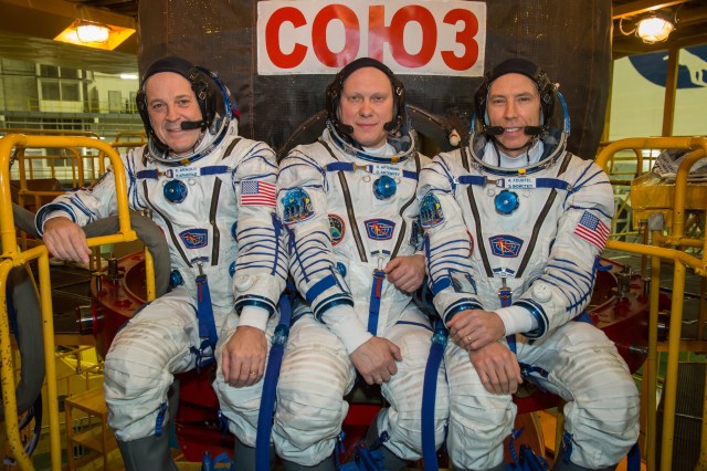 At the Baikonur Cosmodrome in Kazakhstan. Expedition 55 crewmembers Ricky Arnold of NASA (left), Oleg Artemyev of Roscosmos (center) and Drew Feustel of NASA (right) pose for pictures March 5 in front of their Soyuz spacecraft during the crew’s first vehicle fit check activities. Arnold, Artemyev and Feustel will launch March 21 in the Soyuz MS-08 spacecraft from Baikonur for a five-month mission on the International Space Station.