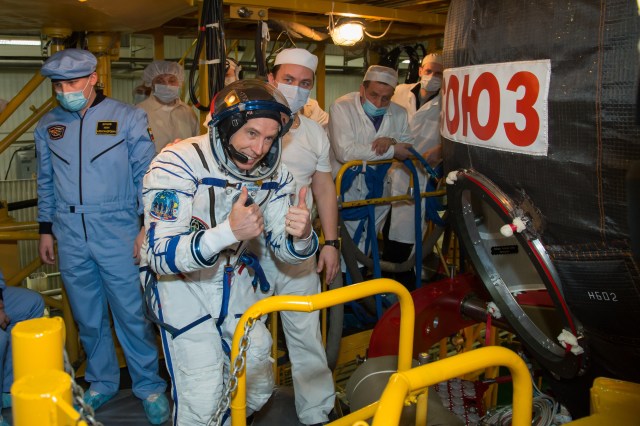 At the Baikonur Cosmodrome in Kazakhstan, Expedition 55 crewmember Drew Feustel of NASA flashes a thumbs up sign as he enters his Soyuz spacecraft during the crew’s first vehicle fit check activities. Feustel, Oleg Artemyev of Roscosmos and Ricky Arnold of NASA will launch March 21 in the Soyuz MS-08 spacecraft from Baikonur for a five-month mission on the International Space Station.