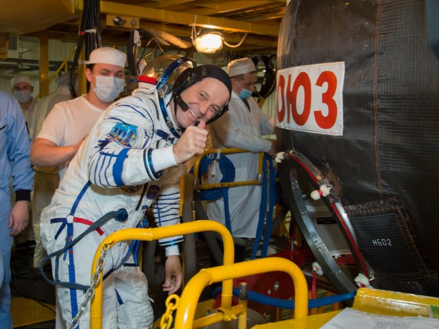At the Baikonur Cosmodrome in Kazakhstan, Expedition 55 crewmember Ricky Arnold of NASA flashes a thumbs up sign as he enters his Soyuz spacecraft during the crew’s first vehicle fit check activities. Arnold, Drew Feustel of NASA and Oleg Artemyev of Roscosmos will launch March 21 in the Soyuz MS-08 spacecraft from Baikonur for a five-month mission on the International Space Station.