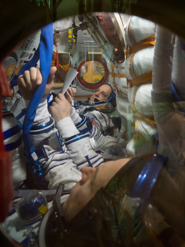At the Baikonur Cosmodrome in Kazakhstan, Expedition 55 crew members Ricky Arnold of NASA (top) and Drew Feustel of NASA (foreground) review procedures March 5 inside their Soyuz spacecraft as part of the crew’s first vehicle fit check activities. Partially obscured in the center seat is crewmate Oleg Artemyev of Roscosmos. They will launch March 21 in the Soyuz MS-08 spacecraft from Baikonur for a five-month mission on the International Space Station.