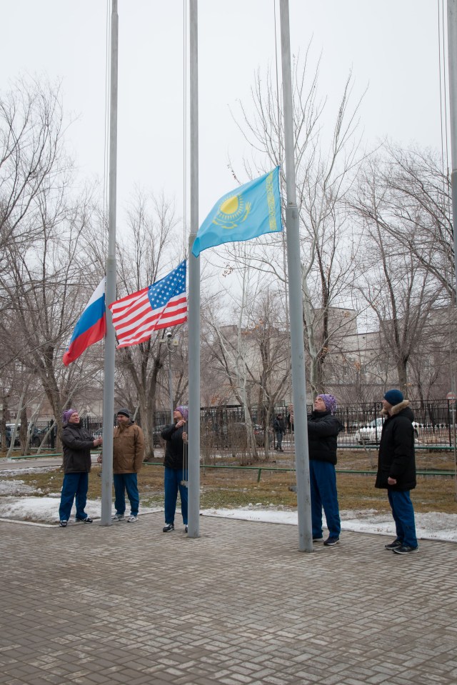 At their Cosmonaut Hotel crew quarters in Baikonur, Kazakhstan, the Expedition 55 prime and backup crew members raise the flags of Russia, the United States and Kazakhstan in traditional pre-launch ceremonies March 6. Drew Feustel and Ricky Arnold of NASA and Oleg Artemyev of Roscosmos will launch March 21 on the Soyuz MS-08 spacecraft from the Baikonur Cosmodrome for a five-month mission on the International Space Station.