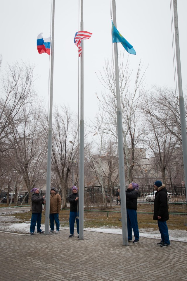 At their Cosmonaut Hotel crew quarters in Baikonur, Kazakhstan, the Expedition 55 prime and backup crew members raise the flags of Russia, the United States and Kazakhstan in traditional pre-launch ceremonies March 6. Prime crewmembers Drew Feustel and Ricky Arnold of NASA and Oleg Artemyev of Roscosmos will launch March 21 on the Soyuz MS-08 spacecraft from the Baikonur Cosmodrome for a five-month mission on the International Space Station.