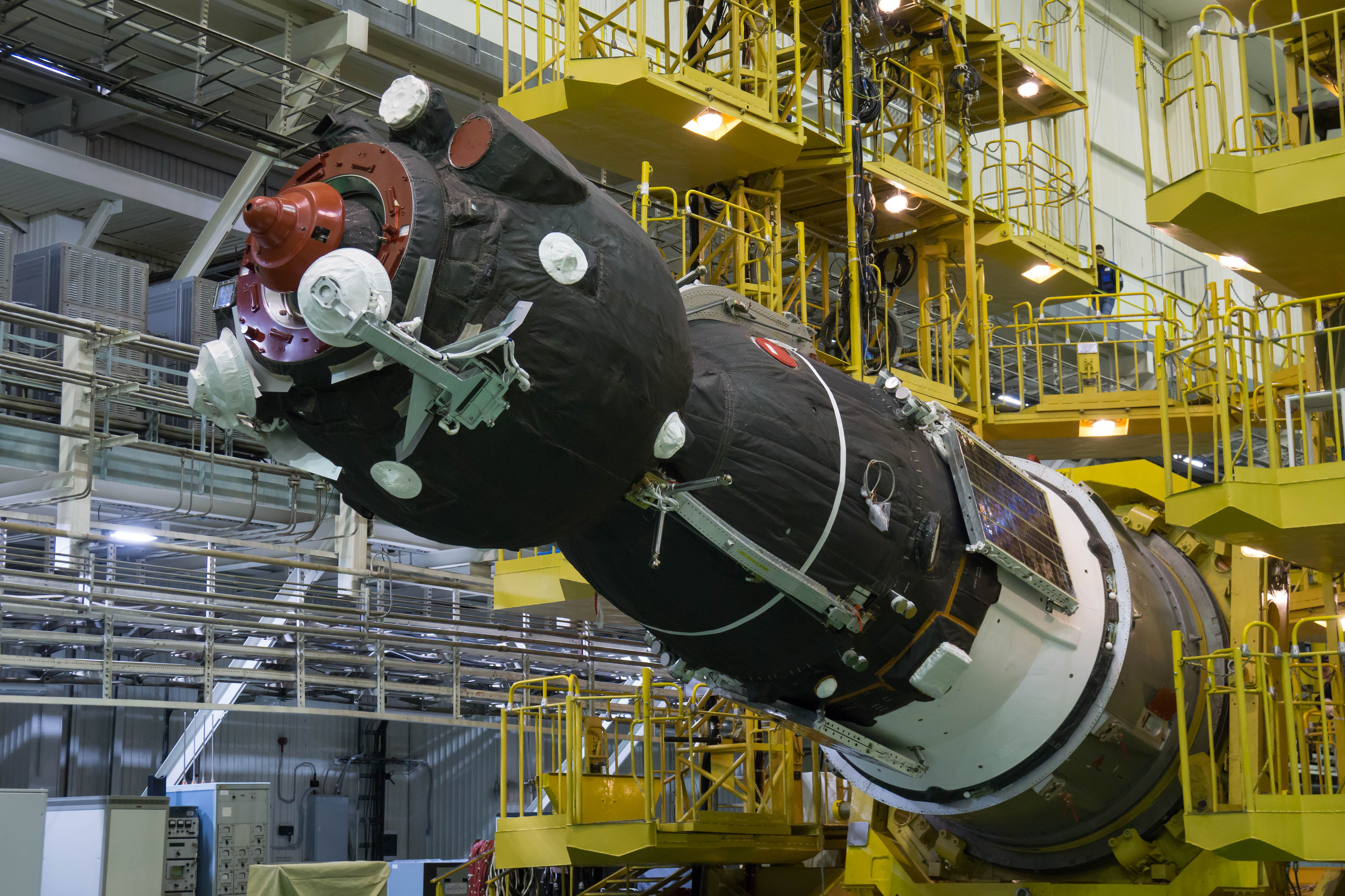 In the Integration Facility at the Baikonur Cosmodrome in Kazakhstan, the Soyuz MS-08 spacecraft is rotated to a horizontal position March 14 to be encapsulated in the upper stage of a Soyuz booster rocket. Expedition 55 crewmembers Drew Feustel and Ricky Arnold of NASA and Oleg Artemyev of Roscosmos will launch in the Soyuz March 21 for a five-month mission on the International Space Station.