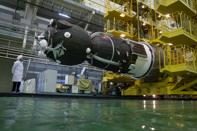 In the Integration Facility at the Baikonur Cosmodrome in Kazakhstan, the Soyuz MS-08 spacecraft is rotated to a horizontal position March 14 to be encapsulated in the upper stage of a Soyuz booster rocket. Expedition 55 crewmembers Drew Feustel and Ricky Arnold of NASA and Oleg Artemyev of Roscosmos will launch in the Soyuz March 21 for a five-month mission on the International Space Station.