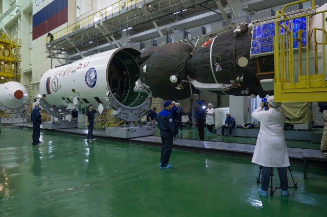 In the Integration Facility at the Baikonur Cosmodrome in Kazakhstan, the Soyuz MS-08 spacecraft (right) is encapsulated into the upper stage of a Soyuz booster rocket March 14. Expedition 55 crewmembers Drew Feustel and Ricky Arnold of NASA and Oleg Artemyev of Roscosmos will launch in the Soyuz March 21 for a five-month mission on the International Space Station.