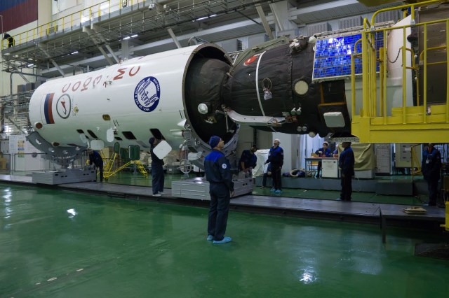 In the Integration Facility at the Baikonur Cosmodrome in Kazakhstan, the Soyuz MS-08 spacecraft is encapsulated into the upper stage of a Soyuz booster rocket March 14. Expedition 55 crewmembers Drew Feustel and Ricky Arnold of NASA and Oleg Artemyev of Roscosmos will launch in the Soyuz March 21 for a five-month mission on the International Space Station.