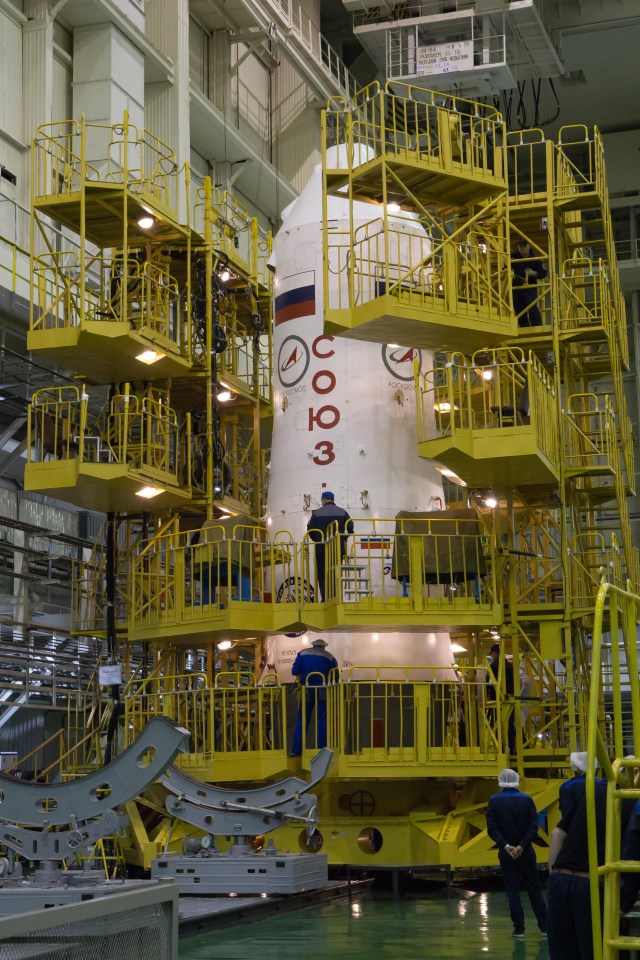 In the Integration Facility at the Baikonur Cosmodrome in Kazakhstan, work platforms are placed in position around the upper stage of a Soyuz booster rocket March 14 for final testing after the Soyuz MS-08 spacecraft was encapsulated into the booster. Expedition 55 crewmembers Drew Feustel and Ricky Arnold of NASA and Oleg Artemyev of Roscosmos will launch in the Soyuz March 21 for a five-month mission on the International Space Station.