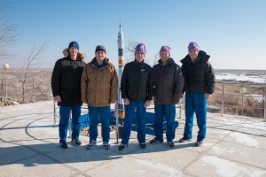 At the Cosmonaut Hotel crew quarters in Baikonur, Kazakhstan, the Expedition 55 prime and backup crewmembers pose for pictures by a Soyuz model March 15 as part of their pre-launch activities. From left to right are backup crewmembers Nick Hague of NASA and Alexey Ovchinin of Roscosmos and prime crewmembers Drew Feustel of NASA, Oleg Artemyev of Roscosmos and Ricky Arnold of NASA. . Arnold, Artemyev and Feustel will launch March 21 on the Soyuz MS-08 spacecraft from the Baikonur Cosmodrome on a five-month mission to the International Space Station.