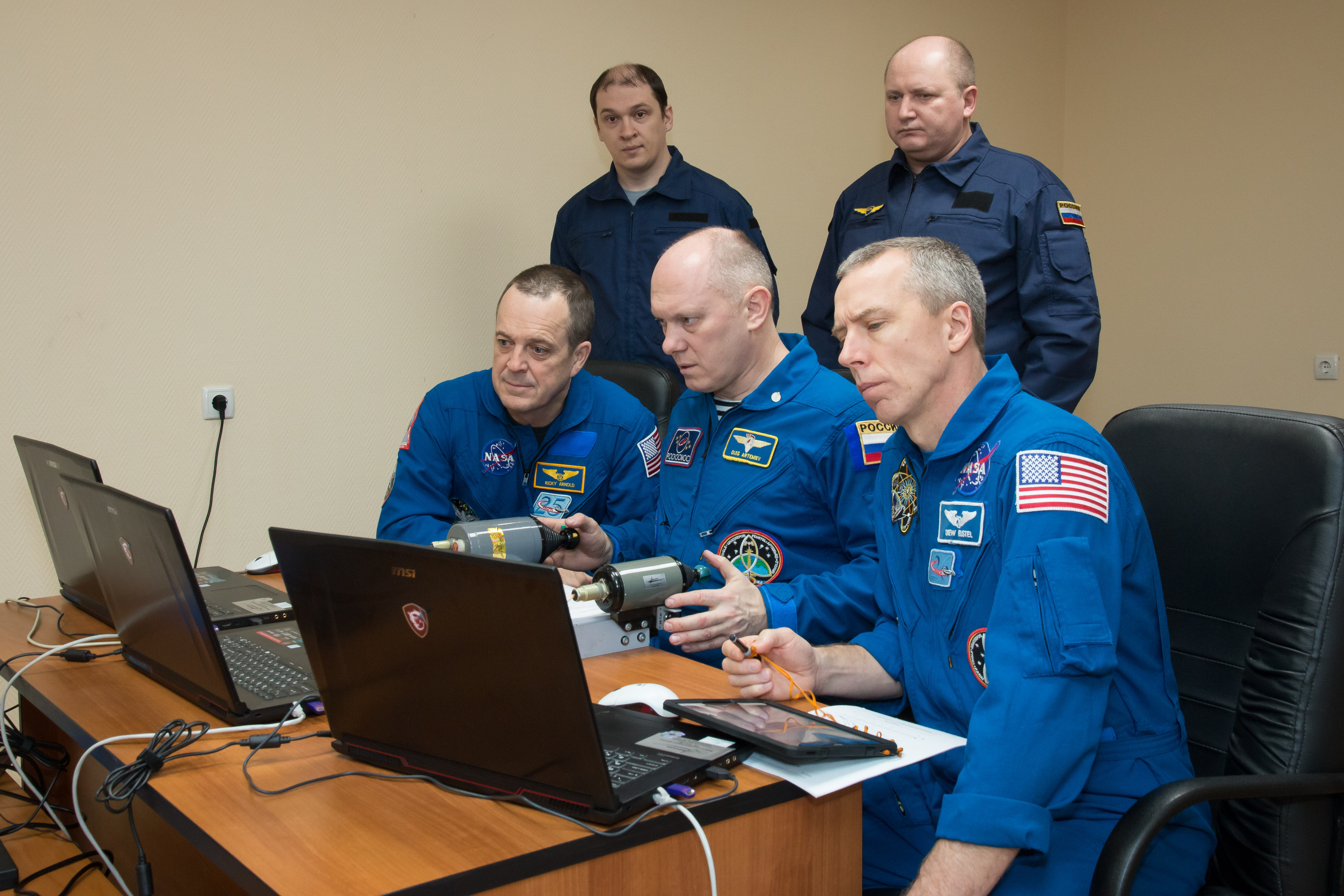 At the Cosmonaut Hotel crew quarters in Baikonur, Kazakhstan, Expedition 55 crew members Ricky Arnold of NASA (left), Oleg Artemyev of Roscosmos (center) and Drew Feustel of NASA (right) practice rendezvous techniques on a laptop computer simulator March 15 as part of their pre-launch activities. They will launch March 21 on the Soyuz MS-08 spacecraft from the Baikonur Cosmodrome on a five-month mission to the International Space Station.