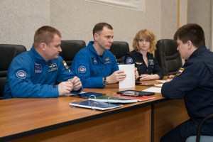 At the Cosmonaut Hotel crew quarters in Baikonur, Kazakhstan, Expedition 55 backup crew members Alexey Ovchinin of Roscosmos (left) and Nick Hague of NASA (center) listen to training instructors March 15 as part of their pre-launch activities. They are serving as backups to the prime crewmembers, Drew Feustel and Ricky Arnold of NASA and Oleg Artemyev of Roscosmos, who will launch March 21 on the Soyuz MS-08 spacecraft from the Baikonur Cosmodrome on a five-month mission to the International Space Station.