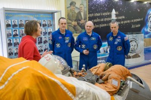 In the Korolev Museum at the Baikonur Cosmodrome in Kazakhstan, Expedition 55 crew members Ricky Arnold of NASA (left), Oleg Artemyev of Roscosmos (center) and Drew Feustel of NASA (right) are shown a mockup of a Soyuz spacecraft seat March 16 during a traditional preflight tour of the museum. They will launch March 21 on the Soyuz MS-08 spacecraft for a five-month mission on the International Space Station.