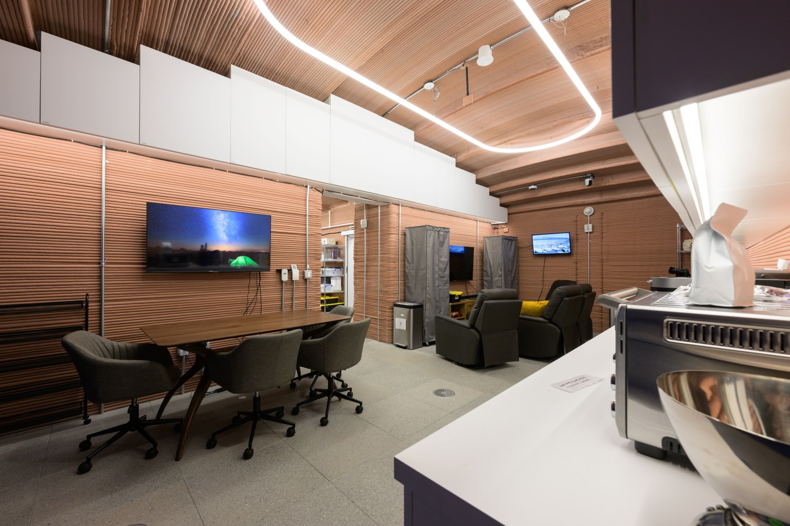 Inside the 3D-printed CHAPEA habitat, a recreational area off the kitchen is available for crew members to enjoy shows and movies together. Credit: NASA/Bill Stafford