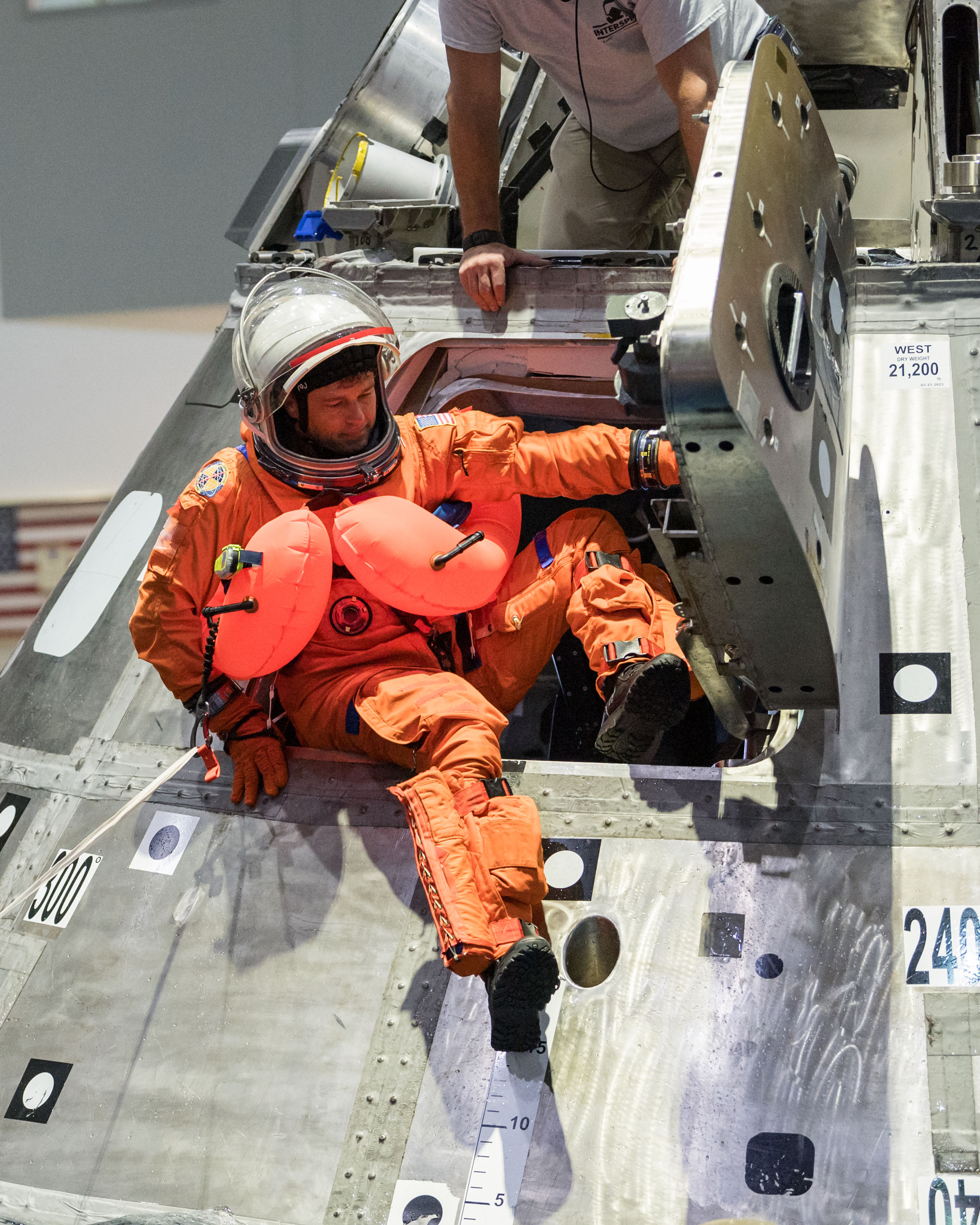 NASA astronaut and Artemis II commander Reid Wiseman exits the side of a mockup of the Orion spacecraft during a training exercise in the Neutral Buoyancy Lab at NASA’s Johnson Space Center in Houston on Jan. 23. As part of training for their mission around the Moon next year, the first crewed flight under NASA’s Artemis campaign, the crew of four astronauts practiced the recovery procedures they will use when the splash down in the Pacific Ocean.