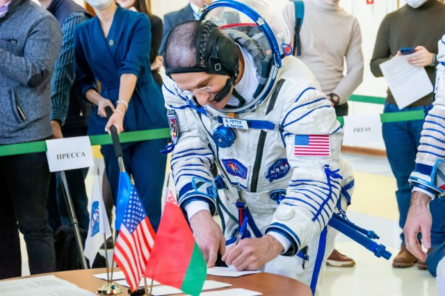 Soyuz MS-25 backup crew member Don Pettit from NASA is pictured in his Sokol launch and entry suit signing in for crew qualification exams at the Gagarin Cosmonaut Training Center in Star City, Russia.