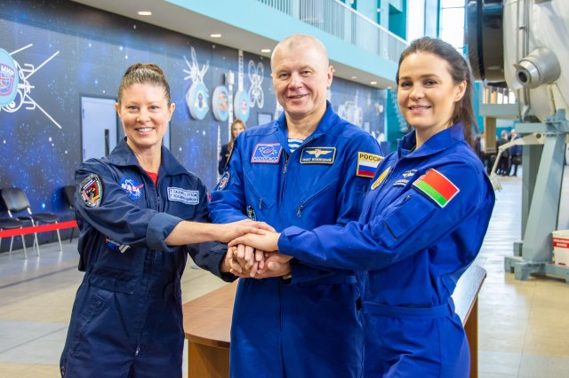 Soyuz MS-25 crew members (from left) Tracy Dyson from NASA, Oleg Novitskiy from Roscosmos, and Belarus spaceflight participant Marina Vasilevskaya join hands during their crew qualification exams at the Gagarin Cosmonaut Training Center in Star City, Russia.