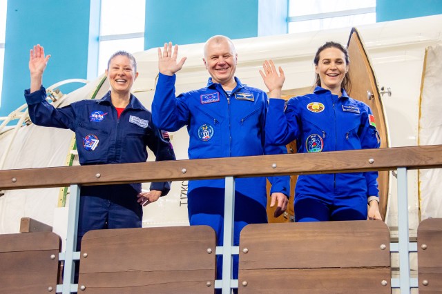Soyuz MS-25 crew members (from left) Tracy Dyson from NASA, Oleg Novitskiy from Roscosmos, and Belarus spaceflight participant Marina Vasilevskaya wave to photographers during their crew qualification exams at the Gagarin Cosmonaut Training Center in Star City, Russia.