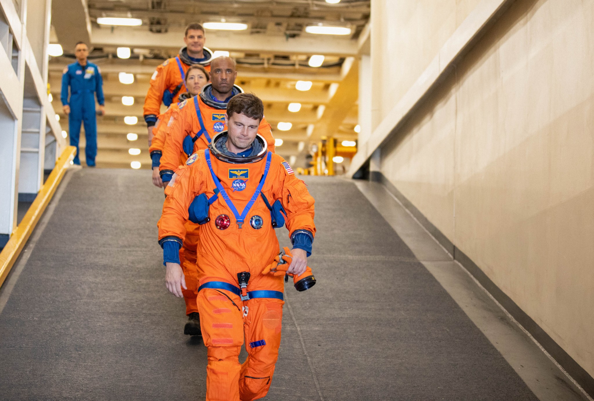 NASA's Artemis II crew members descend the well deck of the USS San Diego as NASA's Exploration Ground System's Landing and Recovery team and partners from the Department of Defense.