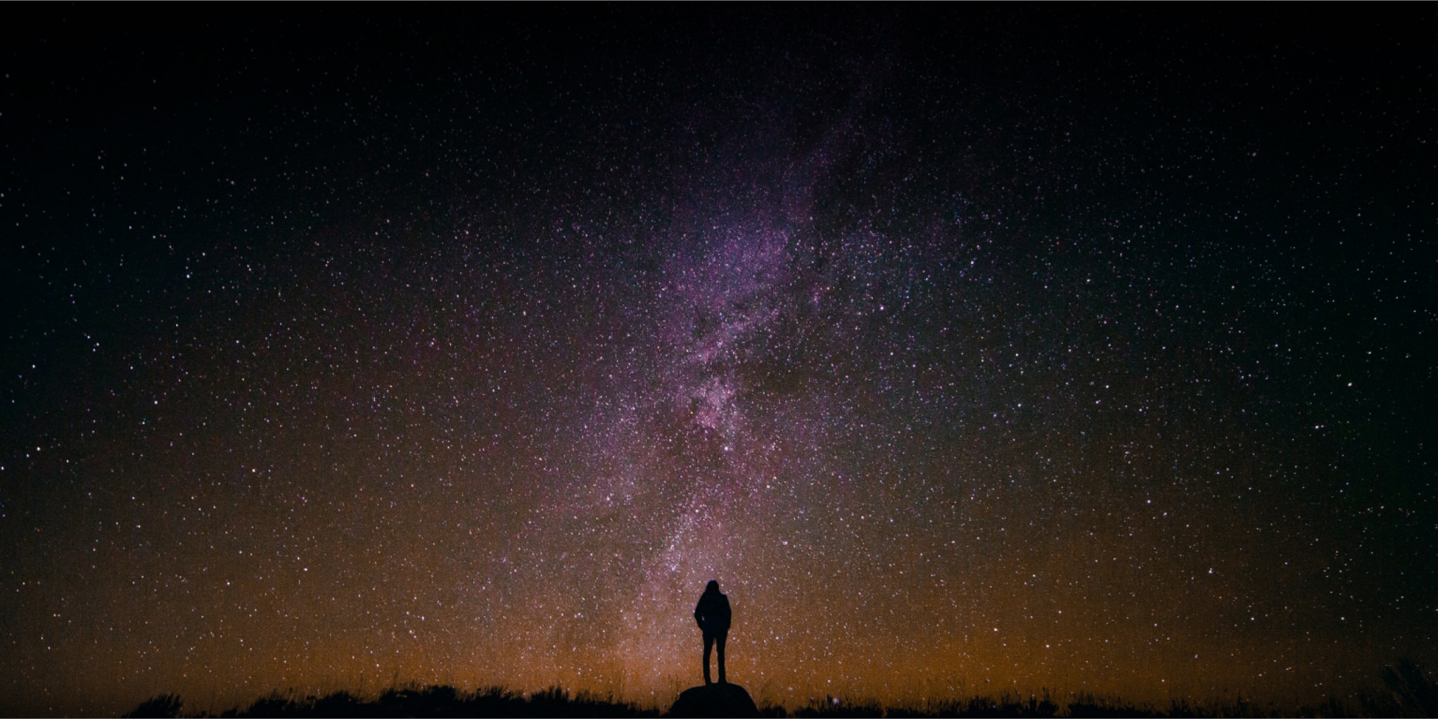 Silhouette of person beneath a starry sky