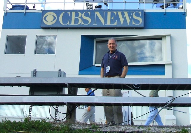A photo of Mark Kramer, producer with CBS News, standing in front of the CBS News building at NASA's Kennedy Space Center.