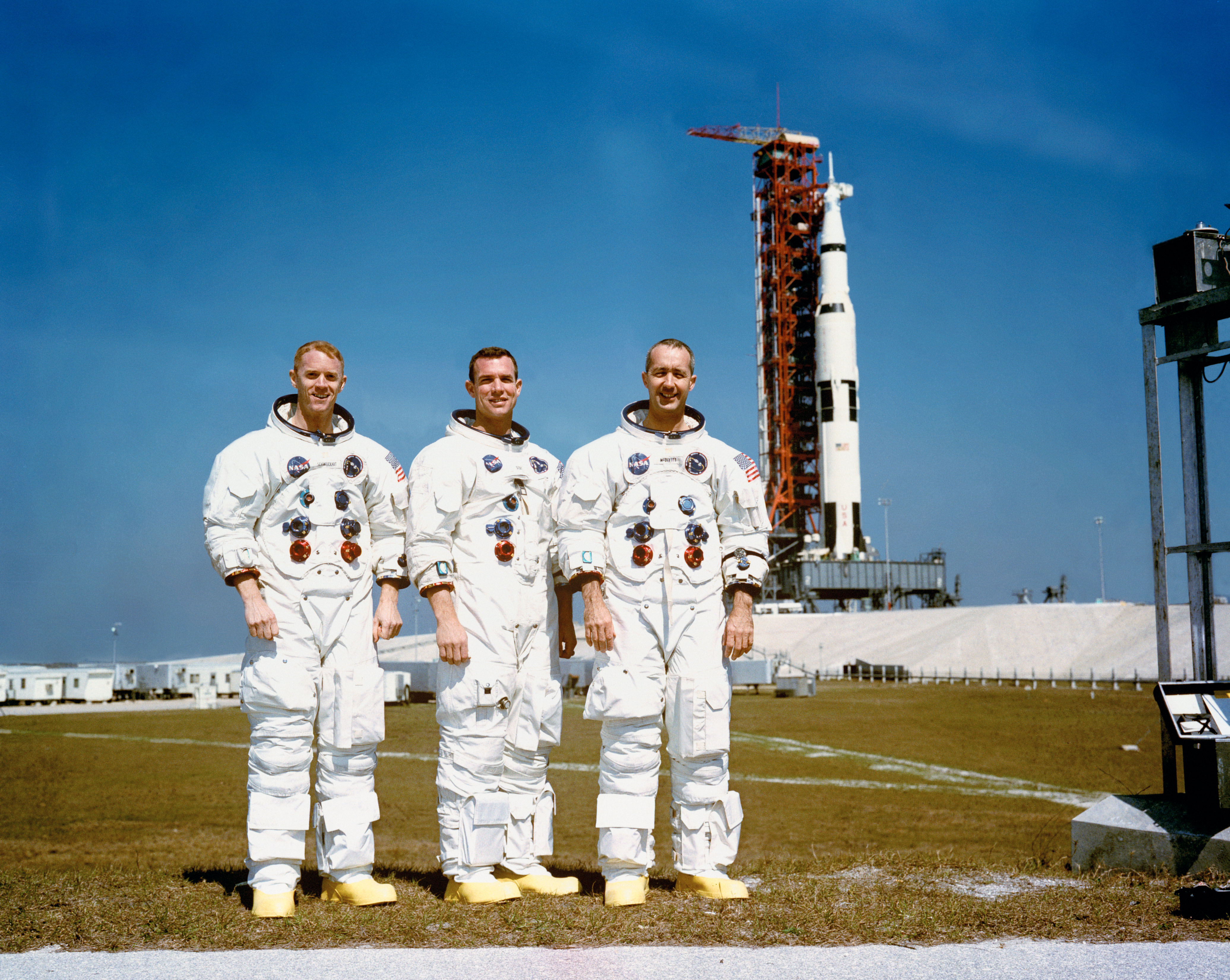 Apollo 9 astronauts Russell L. Schweickart, left, David R. Scott, and James A. McDivitt pose in front of their Saturn V following the CDDT