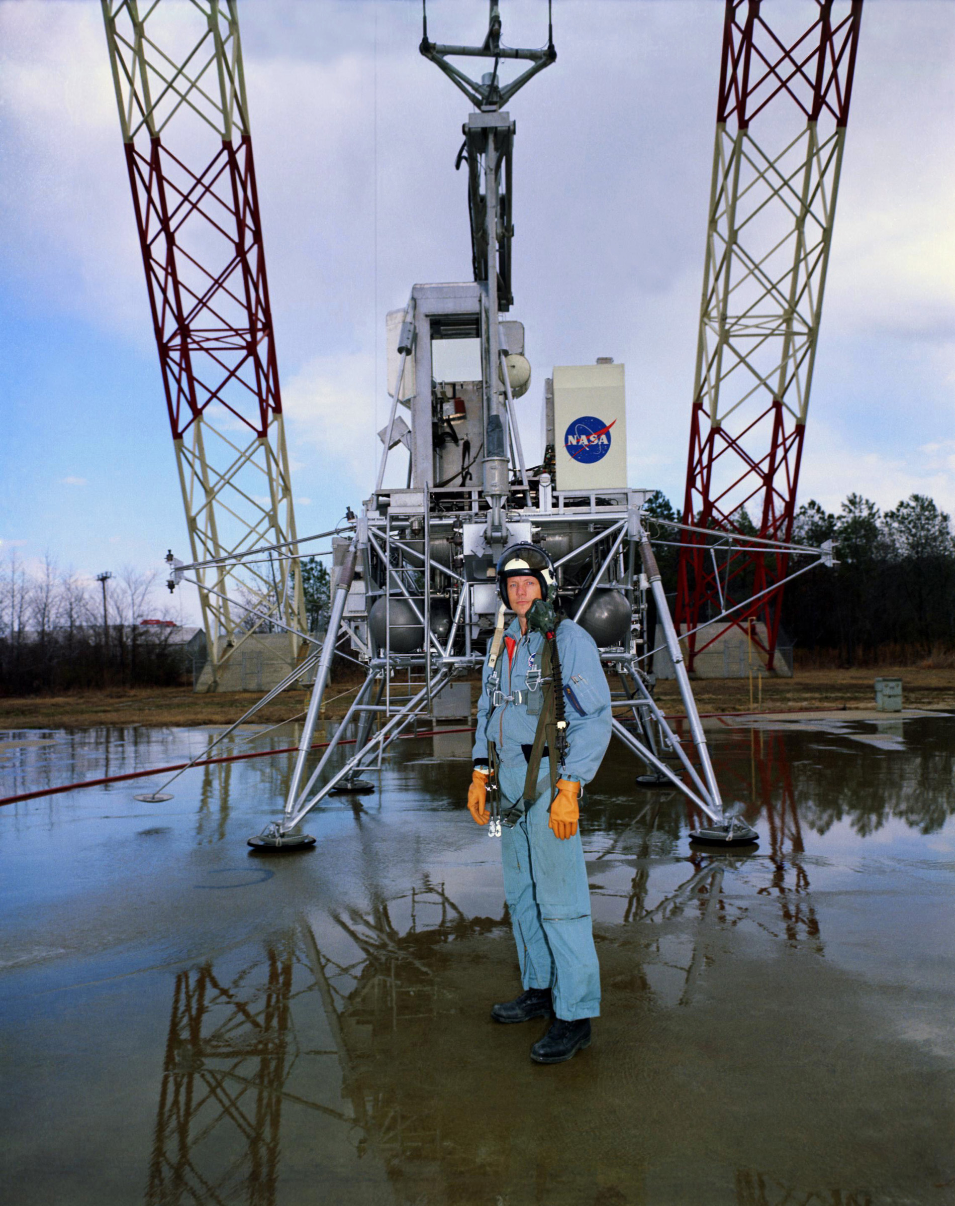 Neil A. Armstrong stands in front of the Lunar Module simulator at the Lunar Landing Research Facility (LLRF) at NASA's Langley Research Center in Hampton, Virginia