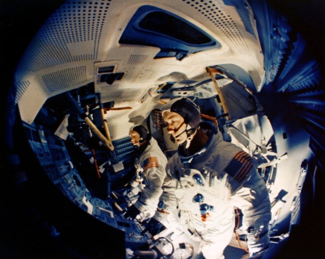 Fisheye lens view of Schweickart, left, and McDivitt in the Lunar Module simulator