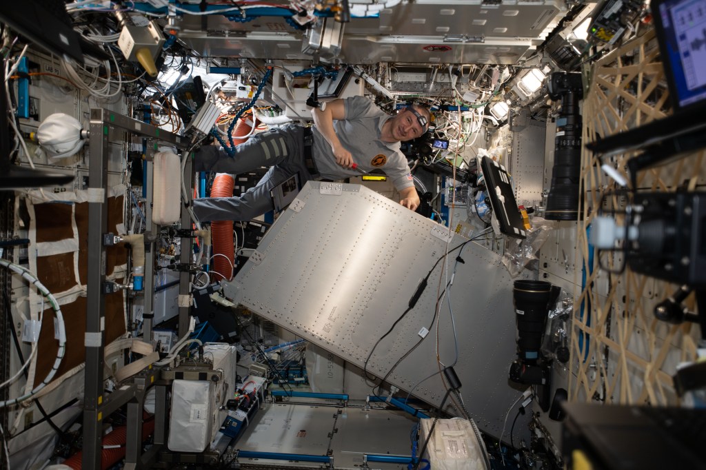 iss062e014085 (Feb. 22, 2020) --- NASA astronaut and Expedition 62 Flight Engineer Andrew Morgan services the Microgravity Science Glovebox (MSG) inside the U.S. Destiny laboratory module. Morgan was cleaning and lubricating the MSG components and photographing the maintenance work for inspection.