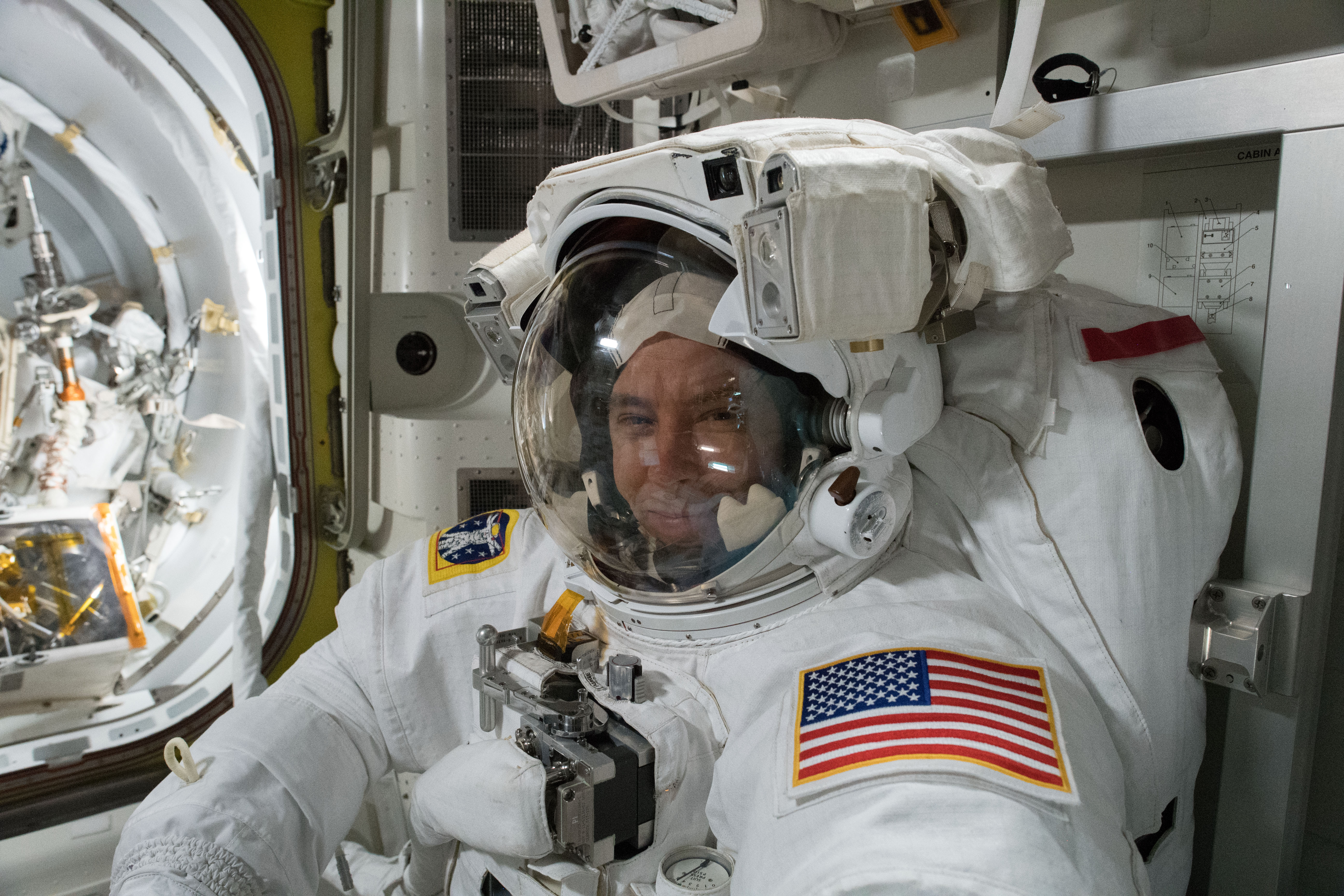 NASA astronaut Drew Feustel is pictured inside a U.S. spacesuit for a fit check verification ahead of a pair of spacewalks.