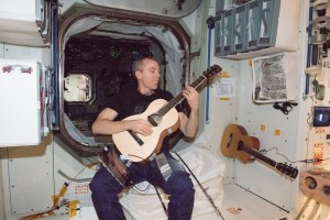 NASA astronaut Drew Feustel relaxes at the end of the workday playing guitar inside the Unity module.